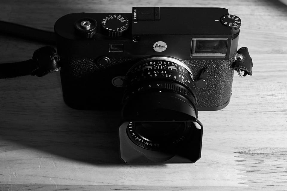 Leica M10-R on a wood table, black-and-white photo showing the top-plate engraving