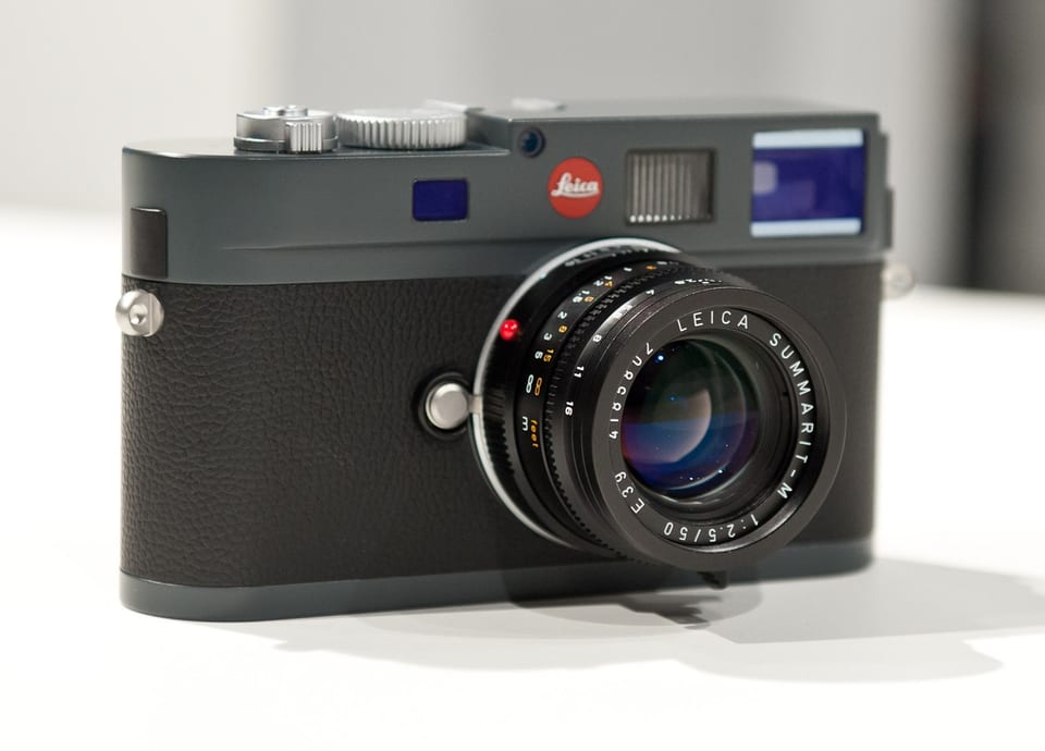 Leica M-E Typ 220 in anthracite grey with a Summarit lens, front view on white